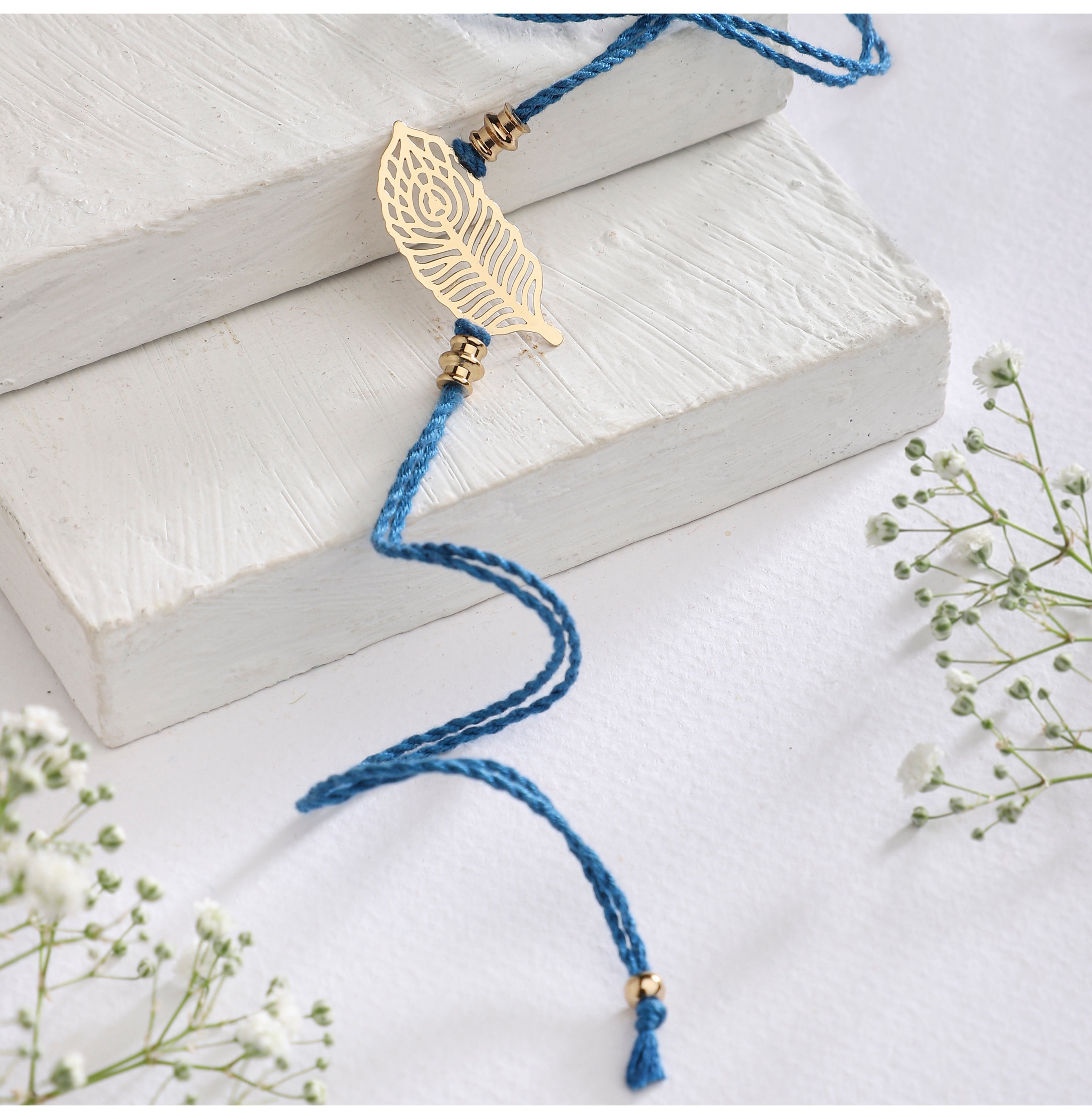 Elegant Peacock Feather Rakhi In Blue By Ananad Prakash